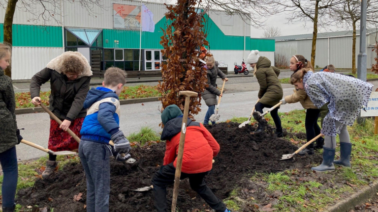 Wethouder en leerlingen planten bomen bij sportvereniging D.T.S.