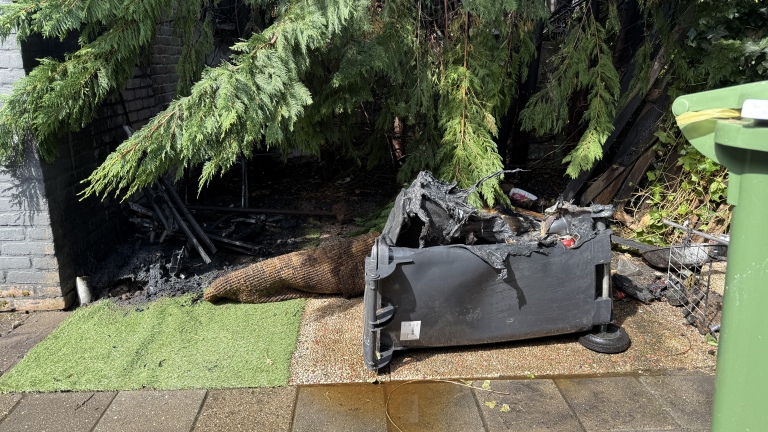 Uitslaande brand in tuin aan Melis Stokelaan; buurvrouw in actie met tuinslang