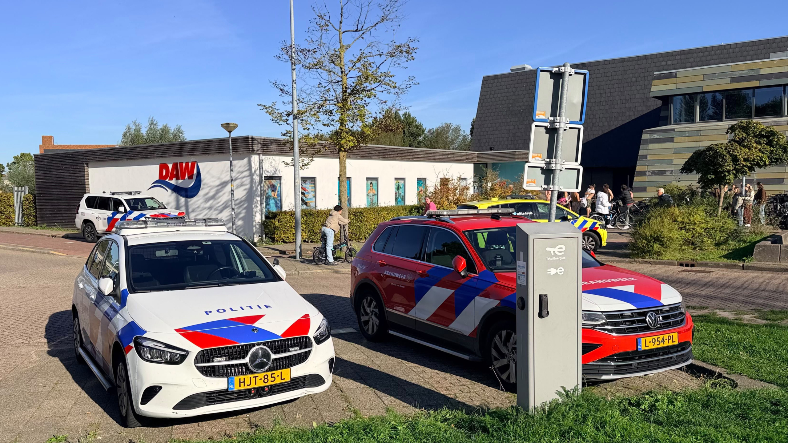 Drukte bij ingang van Sportcomplex Hoornse Vaart, met wachtende mensen, kinderen en fietsenrekken